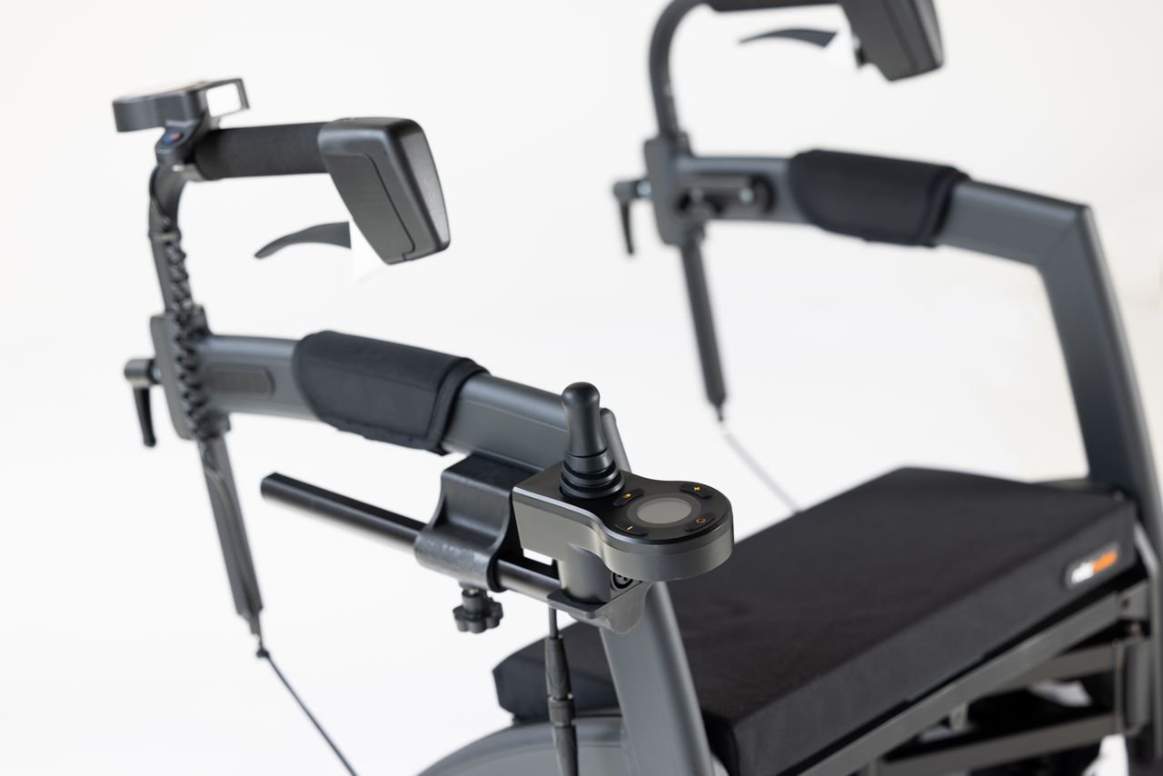 Close-up of a mobility aid showcasing a joystick controller on a sleek black frame.