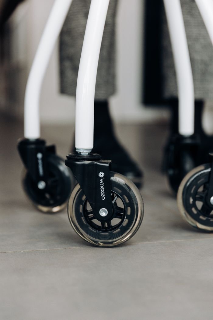 The Art of Drawing Readers In: Your attractive post title goes here Detailed view of sleek walker wheels on a smooth indoor surface, highlighting mobility aids.