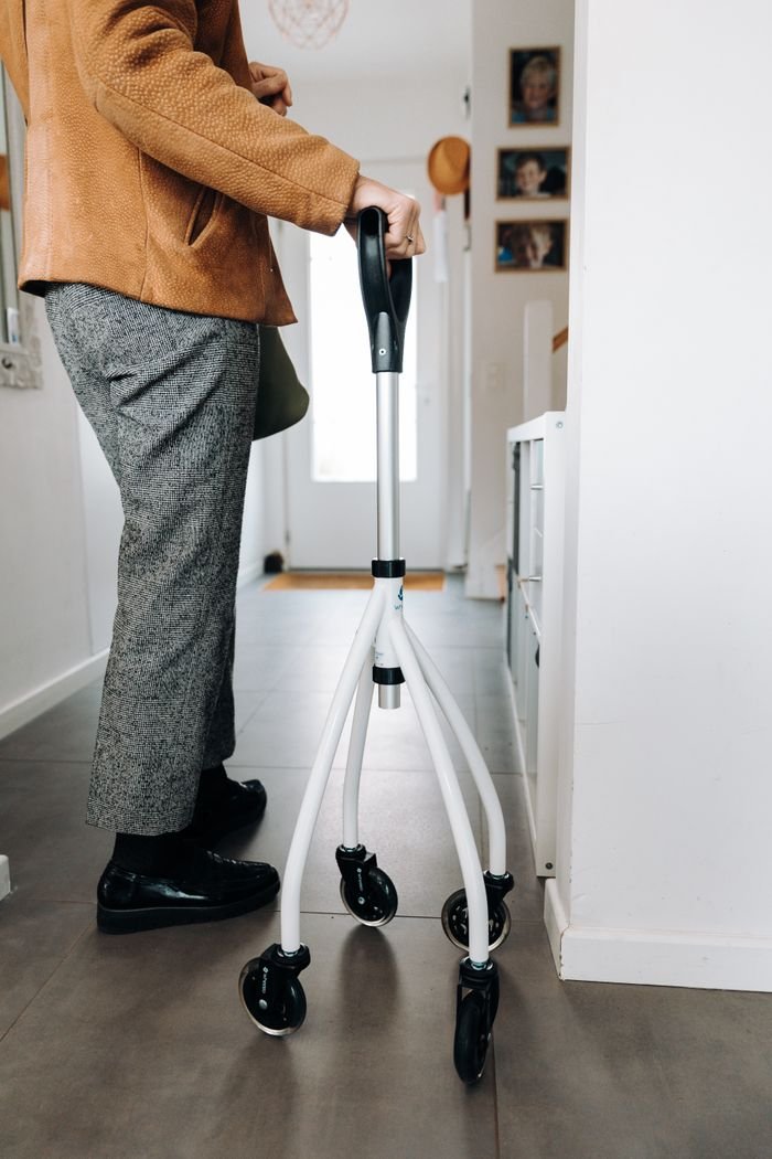 services-01 Person using a rollator in home, showcasing mobility aid in daily life.
